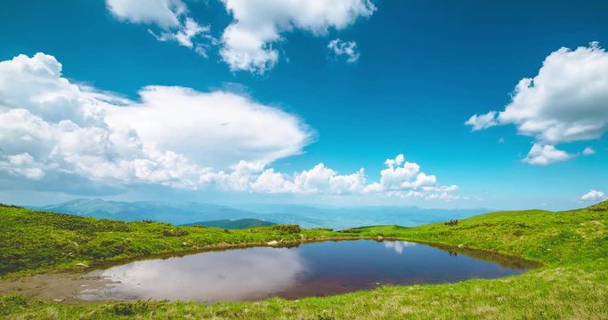 Beautiful lake and clouds in summer Carpathian mountains