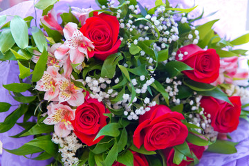 Red flower picture close up in the bouquet . Bouquet of fresh red, white roses . bouquet of multicolored roses .