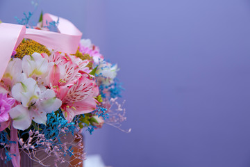 Bouquet of multicolored roses . Pink flower picture close up in the bouquet. Ribbon . Bouquet of fresh Pink, white , blue, orange roses .