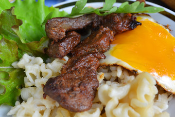 Rural russian cuisine: steak and eggs fried pasta