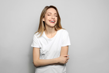 Fototapeta premium Portrait of young woman with beautiful face on grey background