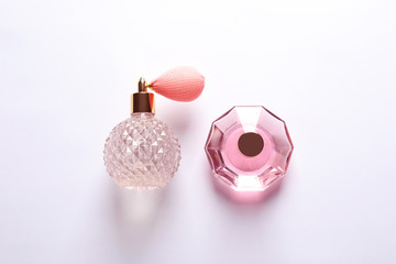 Composition with bottles of perfume on white background, top view