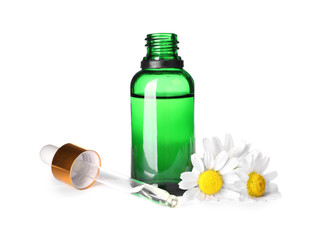 Bottle of chamomile essential oil, pipette and flowers isolated on white