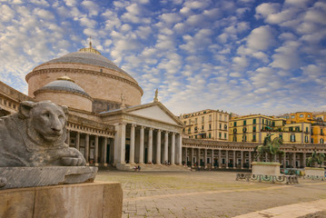Naples, Italy, Exterior view of Basilica Reale Pontificia San Francesco da Paola church on Piazza del Plebiscito, main square of the city, and stone lion sculptures.
