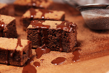 Brownie dessert. Cake chocolate brownies on wooden background with mint.