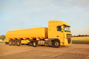 Modern yellow truck parked on country road
