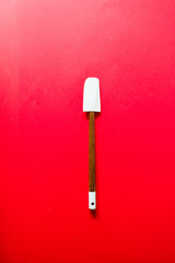 Blue and wooden spatula, tool used  ingredient to prepare  crunchy strawberries crumble, see the other photos of the series