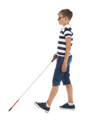 Blind boy with long cane walking on white background