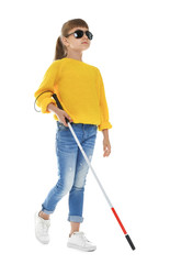 Blind girl with long cane walking on white background