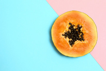 Slice of papaya on color background, top view. Space for text