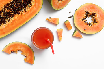Composition with fresh cut papaya and juice on white background, top view