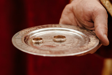 closeup of wedding rings on the holy bible