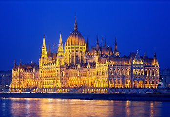 Fototapeta na wymiar The spectacular Hungarian Parliament next to Danube river, on the side of Pest, as seen from the side of Buda. Budapest, Hungary. It is one of the largest parliaments of the world.