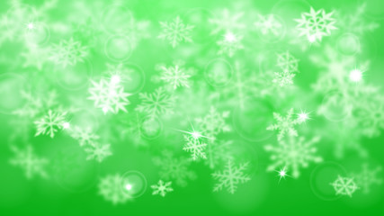 Christmas blurred background of complex defocused big and small falling snowflakes in green colors with bokeh effect