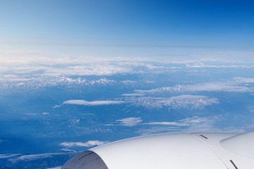 Endless cloudy sky, view from the airplane. Airline theme, travel and business trip by plane