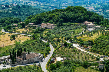 Fototapeta na wymiar Italian landscape of agricultural hills in Picinisco with medieval cemetery church of Santa Maria