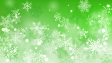 Fototapeta na wymiar Christmas blurred background of complex defocused big and small falling snowflakes in green colors with bokeh effect