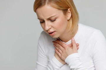 Breathing, respiratory problem, asthma attack, pressure, chest pain concept. Studio portrait of...