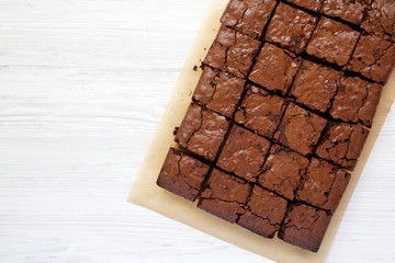 Homemade chocolate brownies on a baking sheet, overhead view. Top view, from above, flat lay. Copy space.