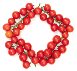 A branch of red cherry tomatoes on a white background. Small and juicy vegetable is rich in vitamins and trace elements. Healthy food. Fresh and organic vegetables. Raw food