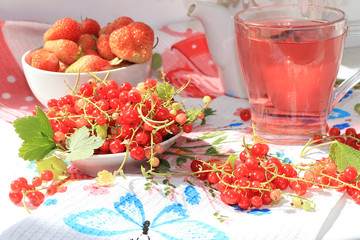 Juicy fresh strawberries and red currants on a sunny window, selective focus. The concept of a healthy diet,