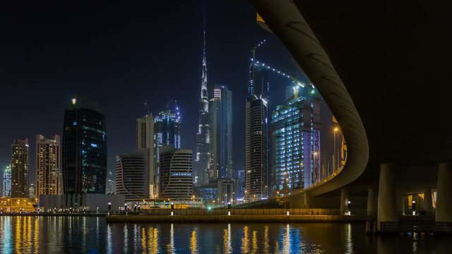 Panoramic view of business bay and downtown area of Dubai, reflection of night illumination of skyscrapers in Dubai creek. UAE