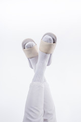 Photo of a male legs in white fashion trendy pants on a white bacakground in studio