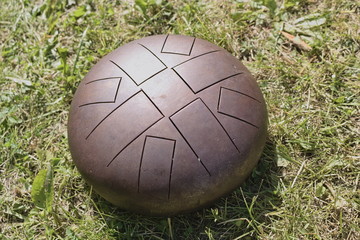 Closeup of Bronze percussion instrument- Hapi. Vibrating plates emit sound