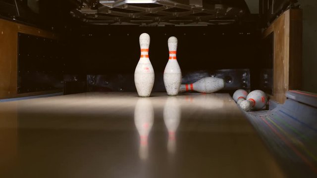 Bowling ball falls into a bowling alley. Frayed Pins