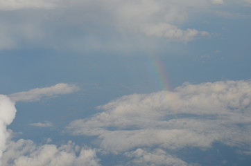 Naklejka na ściany i meble Flying High Amongst the Clouds with a Rainbow