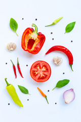 Various fresh vegetables and herbs on white background.