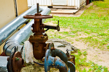 Iron old rusty corrosion-proof industrial metal pipes with flanges valves transitions and branches for the oil and gas petrochemical industry