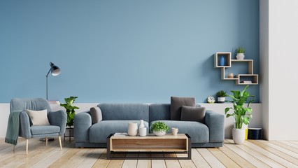 Interior of a bright living room with pillows on a sofa and armchair, plants and lamp on empty blue wall background. 3D rendering