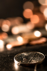 closeup of a nickel on dark background