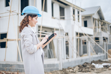 Asian women engineers review the project on the tablet