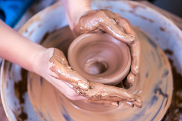 Hands of Experienced Female Potter Working with Clay. Posing with Clay Lump on Potter's Wheel in Workshop.