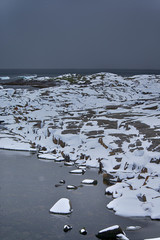 Snowy and Stony Seashore On Lofoten Islands in Norway At Early Spring.