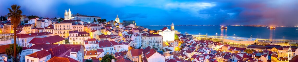 Fototapeta na wymiar Panoramic Image of The Oldest Alfama District in Lisbon in Portugal. Townscape Scenery Was Made During a Blur Hour