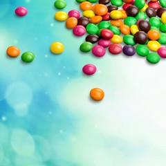Multicolored chocolate balls on a multicolored background close-up