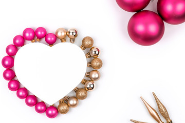 Heart shaped Christmas gift box with  pink and gold Christmas balls with  for holiday, christmas, thanks giving day, birthday top view isolated on white background. 
