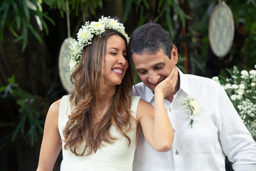 Wedding day bride and Groom showing their love in an outdoor wedding. In love concept. Newly weds...