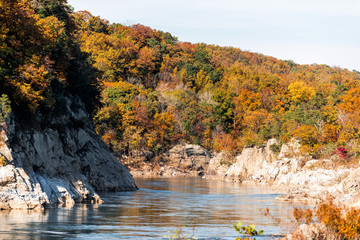 Great Falls orange red autumn trees forest foliage leaves view in Potomac river during autumn in...