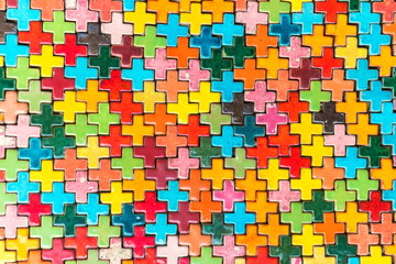 Multicolored plus shaped of ceramic wall tile decorated as the abstract material background and textured