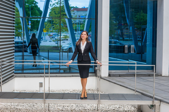 Confident businesswoman in front of modern office building. Business, banking, corporation and financial market concept.