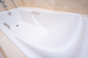 big white bathtub in shower room