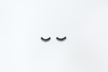 False Eyelashes Lying On White Background. Beauty And Makeup Concept. Flatlay, Mockup, Overhead, Top view