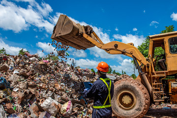 Portrait of Asian Industrial engineer workers with a pile of plastic bottles at the factory for processing and recycling.