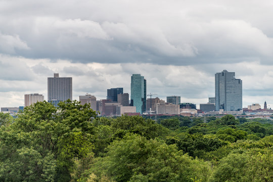 Fort Worth City In Texas With Green Trees In Park And Cityscape Skyline And Cloudy Day