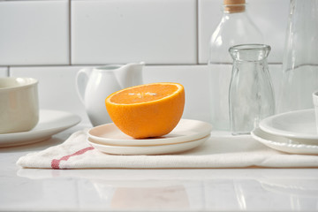 Orange in a dish on the table in the kitchen