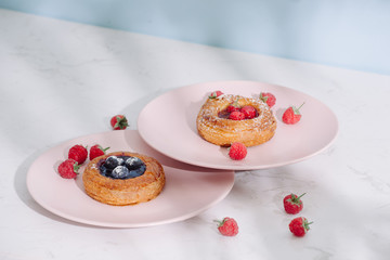 Tasty fresh homemade puff pastry with berries on the white wooden table